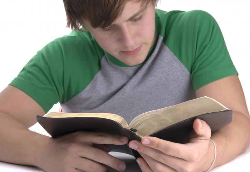 Image: Teenage boy reading Bible